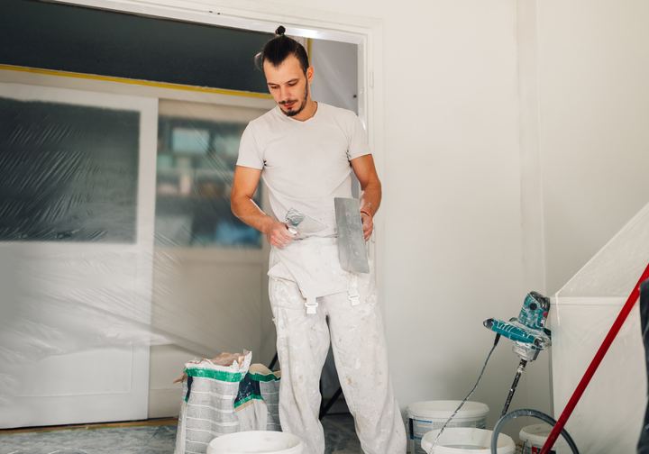Painter smoothing plaster with a trowel
